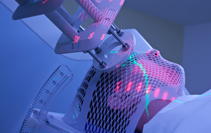 Radiation equipment is used to scan a person protected by netting. 