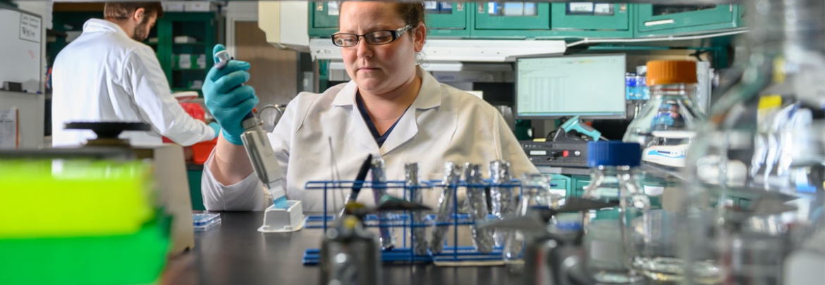 A female researcher works in a lab. 